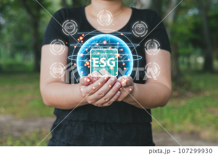 woman are protecting the global to green energy, and reduce world warming, and climate change, ecology friendly investment, ESG for Environment Social and Governance. Sustainable business concept. 107299930