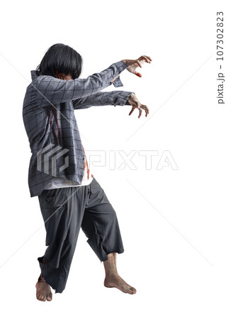 A scary zombie with blood and wounds on his body walking 107302823