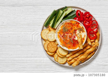 Hot Pepper Jelly Cheese Dip with crackers, veggies 107305180