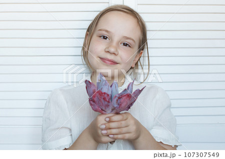 Cute child girl holding flowers on white background Cute child girl holding flowers on white background 107307549
