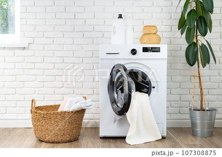 Washing machine and basket in a laundry room 107308875