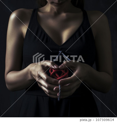 woman hands tired up with rope holding red blood heart torune pain concept woman hands tired up with rope holding red blood heart torune pain concept 107309614