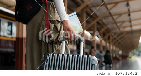 Travel concept at train station, Young Tour woman asian walking dragging luggage suitcase bag. Asian women waiting for train and map planning happy holiday vacation Travel concept at train station, Young Tour woman asian walking dragging luggage suitcase bag. Asian women waiting for train and map planning happy holiday vacation 107312432
