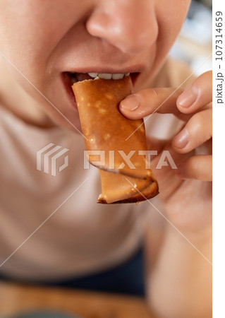 woman slowly eats flour for breakfast in the morning 107314659
