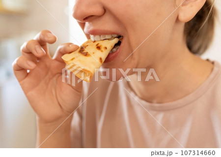 woman eating gluten-free pancakes at breakfast 107314660