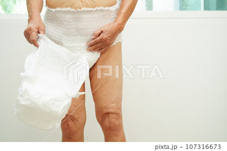 Asian senior woman patient wearing adult incontinence diaper pad in hospital. Asian senior woman patient wearing adult incontinence diaper pad in hospital. 107316673