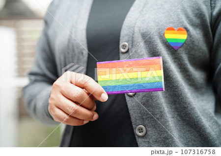 Asian woman with rainbow flag, LGBT symbol rights and gender equality, LGBT Pride Month in June. 107316758