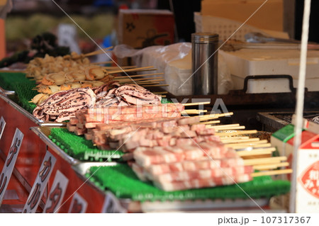 skewer pork and seafood in japanese food stall in the food market of Asakusa, japan 107317367