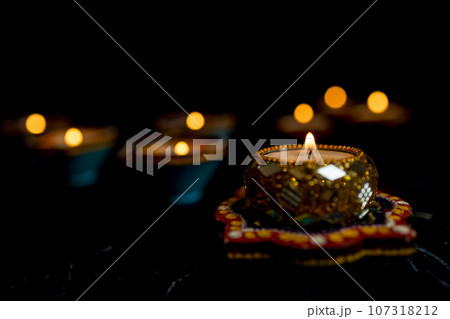 Happy Diwali - Clay Diya lamps lit during Dipavali, Hindu festival of lights celebration. 107318212