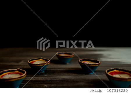 Happy Diwali - Clay Diya lamps lit during Dipavali, Hindu festival of lights celebration. Happy Diwali - Clay Diya lamps lit during Dipavali, Hindu festival of lights celebration. 107318289