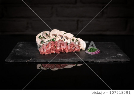 Minced meat and mushrooms, pork beef farce, dark background 107318391