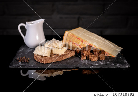 Ingredients cheese and bread for Fonduta, Piedmontese Fondue Ingredients cheese and bread for Fonduta, Piedmontese Fondue 107318392