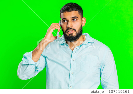 Disinterested tired Indian man having annoyed boring talk on smartphone online conversation, quarrel 107319161