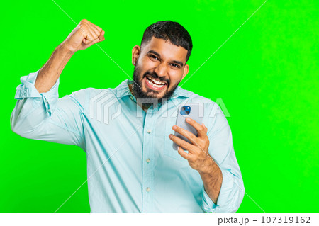 Happy excited winner man use smartphone celebrating success, winning play game, good lottery news 107319162