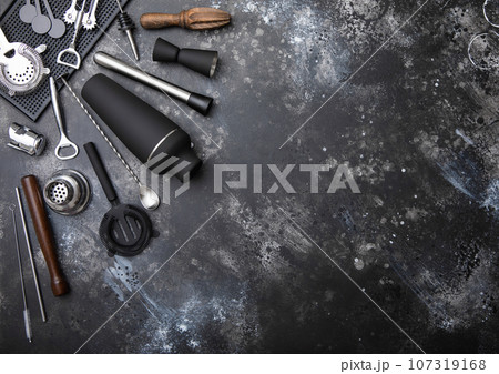 Black matt steel shaker,pourer,spoon,strainer,muddler and jigger on light bsckground. 107319168