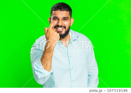 Confused young Indian man knocking door gesture asking who is at home, feeling embarrassed, no idea 107319196
