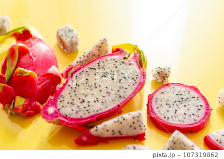 Slices of fresh white pitaya or dragon fruit on yellow background, flat lay Slices of fresh white pitaya or dragon fruit on yellow background, flat lay 107319862