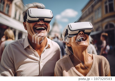 Senior mature couple having fun with virtual reality glasses. Old people using new headset goggles trends technology 107320583