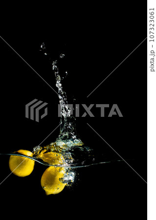 bright juicy fruits with splashes on black background. 107323061