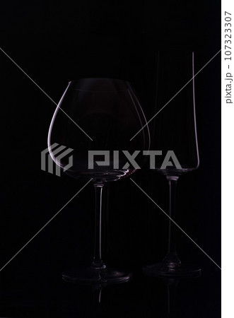 Empty wine glass isolated on black Empty wine glass isolated on black 107323307
