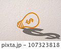 Abstract orange thinking light bulb and dollar shadow on concrete wall background 107323818