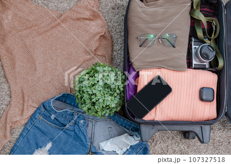 arrangement of clothes and accessories in a suitcase,Travel concept. arrangement of clothes and accessories in a suitcase,Travel concept. 107327518