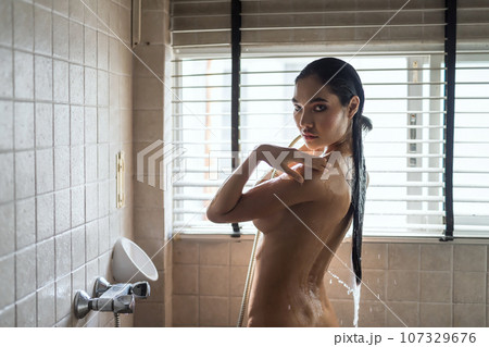 Nude Asian girl spray water to body. Nake woman bathing 107329676