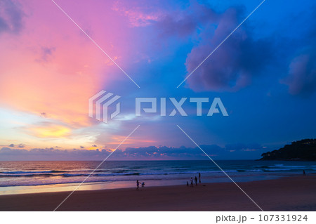 amazing pink sky above Karon beach Phuket at colorful sunset. sweet sky in colorful sunset above the ocean. Imagine a fantasy bright pink in blue sky at sunset. Sky texture background. 107331924