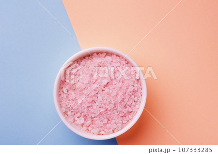 aromatic pink Himalayan sea salt on two colors pink blue background. Skincare spa beauty bath cosmetic products for relax. Natural skin care. Top view, copy space. Home spa. Aromatherapy 107333285