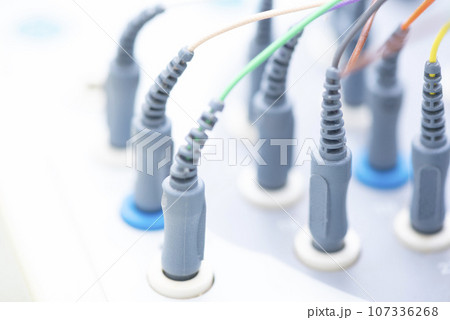 Cables of EEG machine plugged-in the socket 107336268