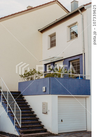 Traditional Small House With Beautiful Outdoor Decor Facade In Germany. German Old Brick Building House Ancient European City German Architect 107339625