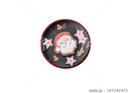 A beautiful Christmas composition consisting of ceramic plates, gingerbread and other elements 107342473