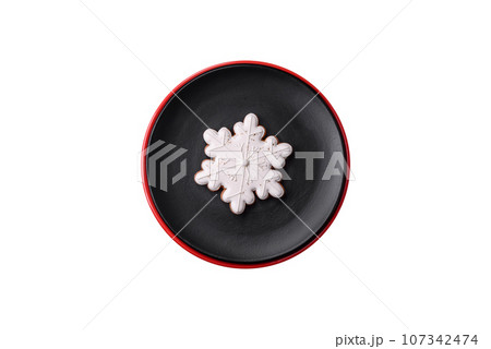 A beautiful Christmas composition consisting of ceramic plates, gingerbread and other elements 107342474