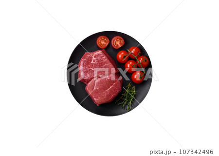 Raw fillet steak mignon beef with salt, spices and herbs 107342496