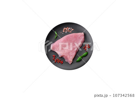 Raw turkey meat in the form of slices with salt, spices and herbs 107342568