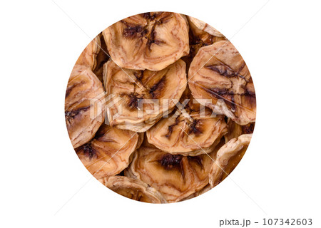 Round slices of sweet banana on a dark concrete background 107342603