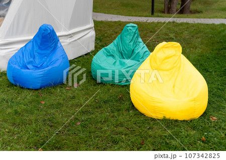colored comfortable bag chair on the grass in the park for outdoor recreation colored comfortable bag chair on the grass in the park for outdoor recreation 107342825