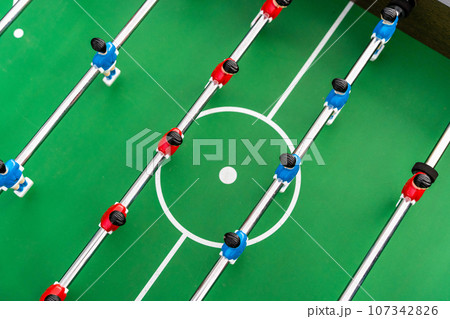 Top view of the football field and plastic players at a football match Top view of the football field and plastic players at a football match 107342826