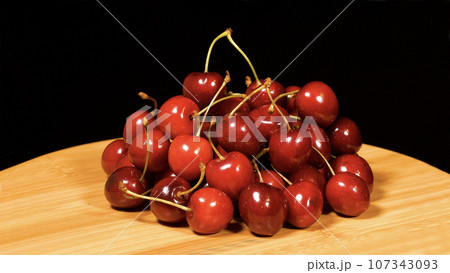 Close-up footage of cherry fruit on black background. Close-up footage of cherry fruit on black background. 107343093