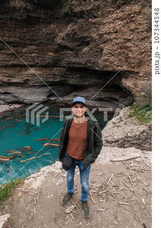 bearded Caucasian male traveler on background of river in Aksu canyon in Kazakhstan in spring bearded Caucasian male traveler on background of river in Aksu canyon in Kazakhstan in spring 107344548