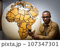 African man with a globe. Generated with AI 107347301
