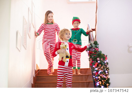 Kids running stair on Christmas morning Kids running stair on Christmas morning 107347542