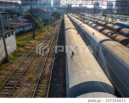 Railroad in the city. Many railway paths. Wagons and trains on the tracks. unloading station. Tank wagons. Railroad in the city. Many railway paths. Wagons and trains on the tracks. unloading station. Tank wagons. 107350815