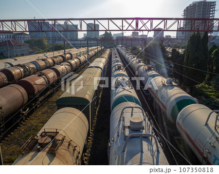 Railroad in the city. Many railway paths. Wagons and trains on the tracks. unloading station. Tank wagons. Railroad in the city. Many railway paths. Wagons and trains on the tracks. unloading station. Tank wagons. 107350818