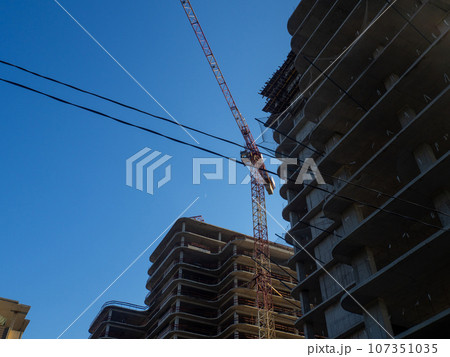 Construction of a tall building. Building frame. Construction of a hotel in the south. The gray building of their concrete. High-altitude work. 107351035