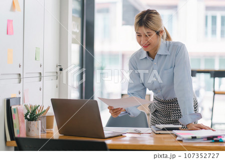 Financial analyst or accountant analyze business financial reports on a digital laptop to planning investment project. 107352727