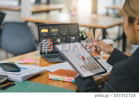 Advisor financial business analytics woman analyzing data charts, graphs, and a dashboard on laptop screen. Data analysis concept 107352728