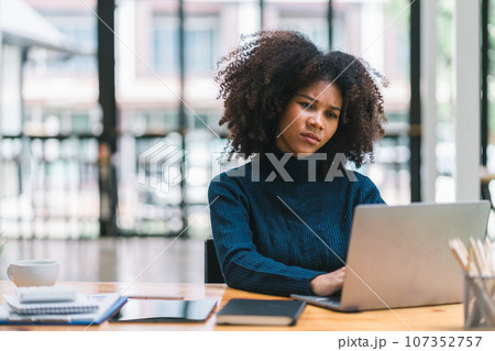 Tired frustrated young African American businesswoman feeling stressed ,thoughtfulness,contemplation, or deep concentration. Business problem failure concept 107352757