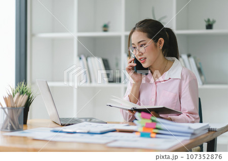 Portrait of beautiful asian secretary woman working with cellphone and laptop in office. 107352876