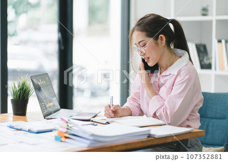 Portrait of beautiful asian secretary woman working with cellphone and laptop in office. Portrait of beautiful asian secretary woman working with cellphone and laptop in office. 107352881